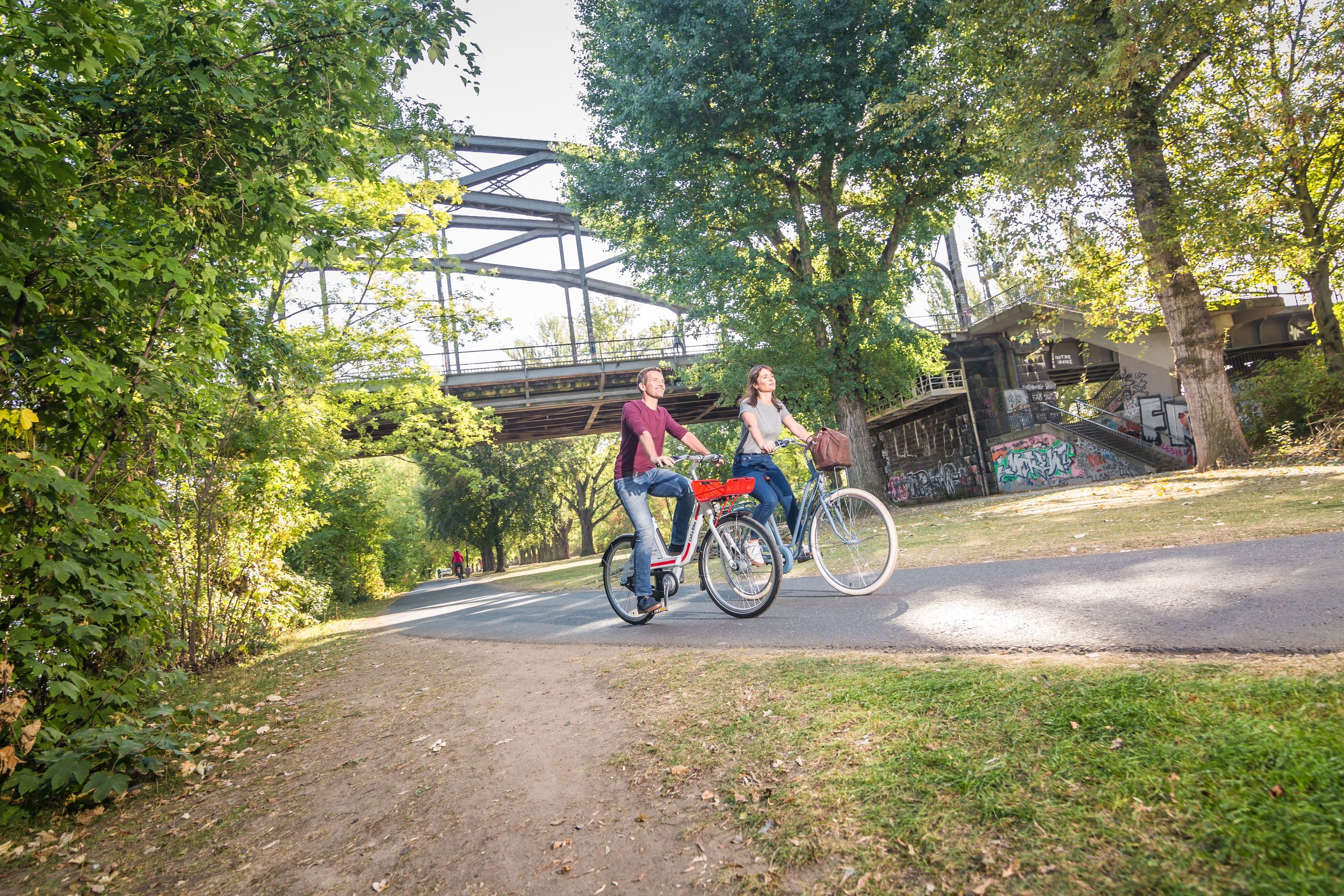 Man and woman cycling in a park