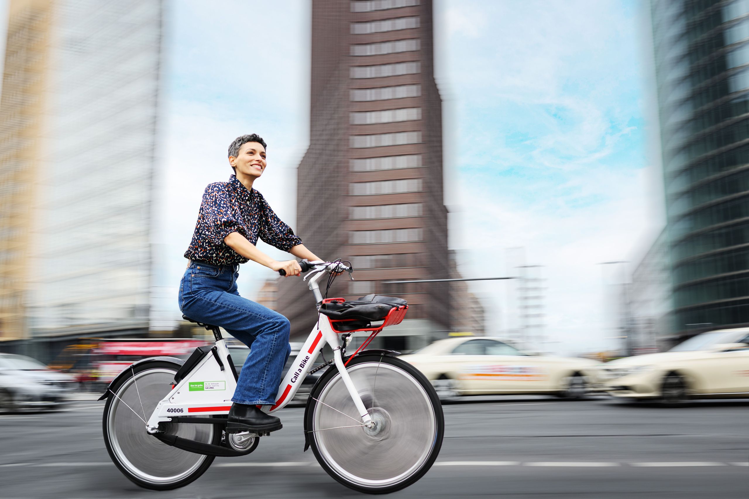 A woman rides a Call a Bike